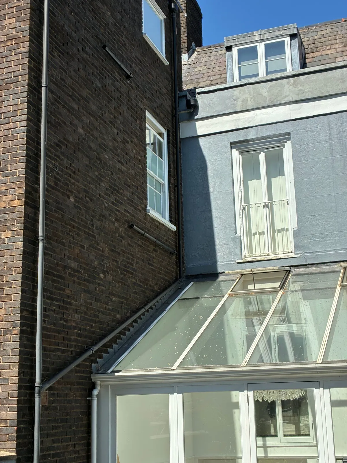 Boiler flue position above the glass conservatory roof on a tall Hampton townhouse